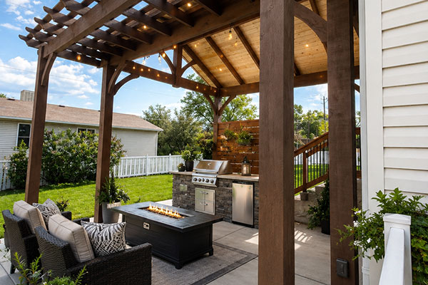 Cozy backyard patio with pergola and fire table